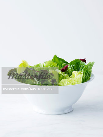 Mixed salad leaves in white bowl