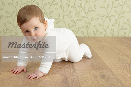 Baby girl crawling on floor