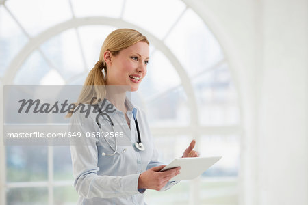 Portrait of female doctor with stethoscope and digital tablet