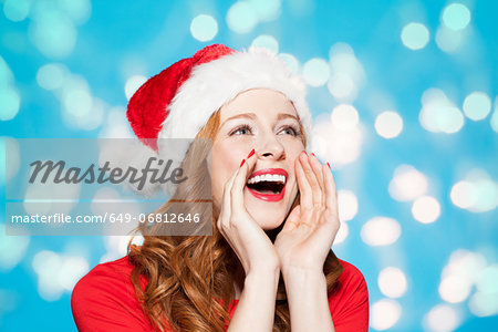 Woman wearing santa hat, shouting