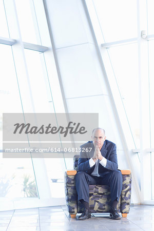 Mature businessman sitting in chair