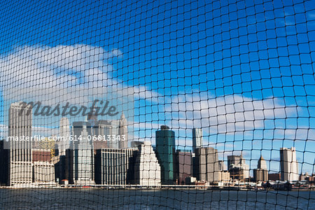 View of Manhattan skyline through netting, New York City, USA