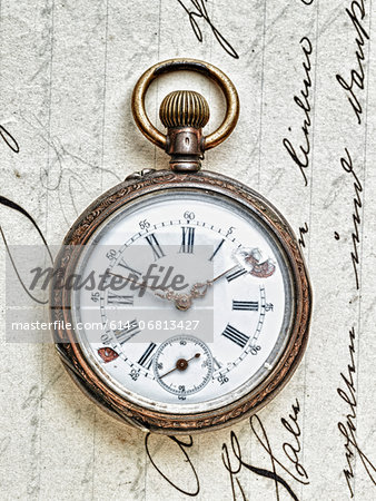 Pocket watch on handwritten letter