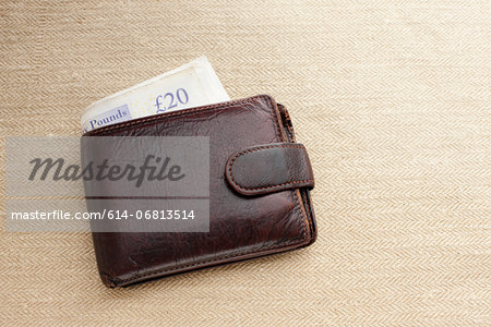 Brown leather wallet with twenty pound note
