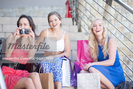 Three young women taking photo of the camera person