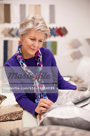 Senior woman choosing textile swatches