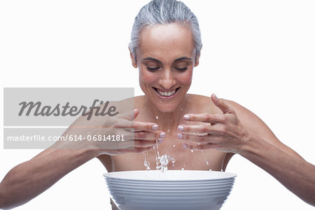 Mature woman washing face