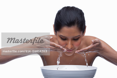 Young woman washing face