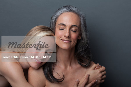 Young woman and mature woman hugging