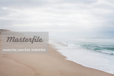 Quiet beach scene with misty horizon