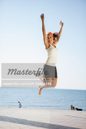 Young woman jumping mid air