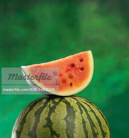 Whole and a slice of watermelon