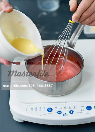 Adding the melted butter to the strawberry puree for the confectioner's custard