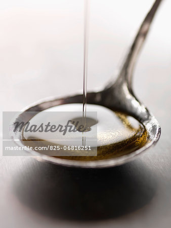 Pouring a spoonful of olive oil