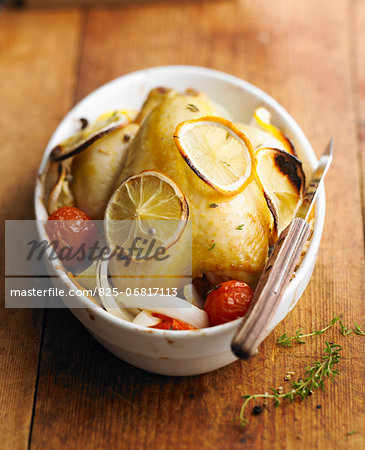 Young cockerel with lemon and cherry tomatoes