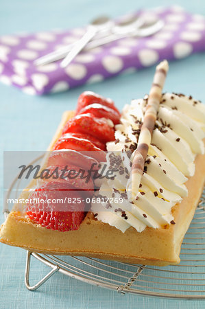 Waffle with whipped cream and strawberries