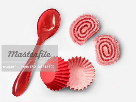 Raspberry rolled candies and paper cups