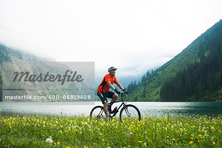 Mature Man Riding Mountain Bike by Vilsalpsee, Tannheim Valley, Tyrol, Austria