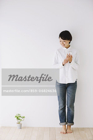 Young woman in a white shirt using smart phone