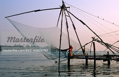 India, Kerala, Cochin, Fort Cochin, traditional fishing and fishermen in the early morning sunlight