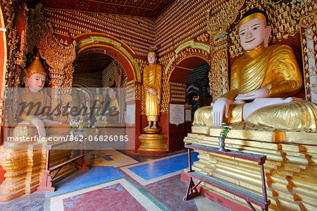 Myanmar, Burma, Sagaing Region, Monywa. Built in 1939, the Thanboddhay Paya, or temple, near Monywa is famed for its extraordinary array of Buddha statues, large and small, that fill its walls and ceilings.