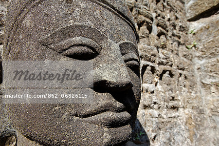 Myanmar, Burma, Rakhine State, Mrauk U. A carved face depicting the Buddha - one of a reputed 90,000 of varying size and style - graces an ambulatory passageway at Kothaung Paya, a part-restored 16th-century temple and the largest in Mrauk U.