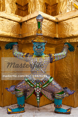 Thailand, Bangkok.  Statue at Wat Phra Kaeo, Temple of the Emerald Buddha, within the grounds of the Royal Grand Palace.
