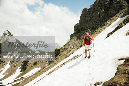 Backview of mature man hiking in mountains, Tannheim Valley, Austria