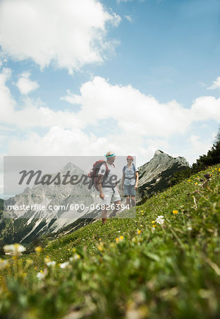 Mature couple hiking in mountains, Tannheim Valley, Austria