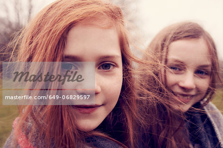 Portrait of girls wrapped in a blanket outdoors, smiling