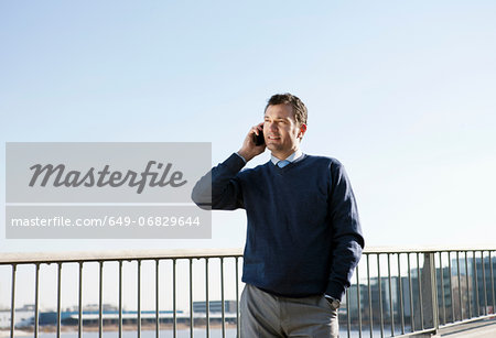 Mature man using cellphone outdoors