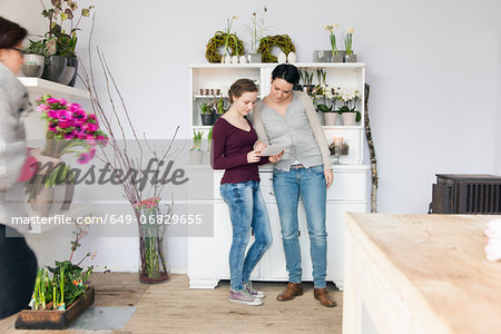 Mid adult woman and teenage girl in florists