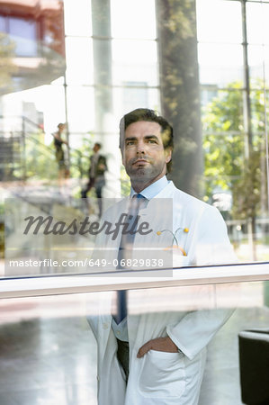 Portrait of male doctor looking out of window
