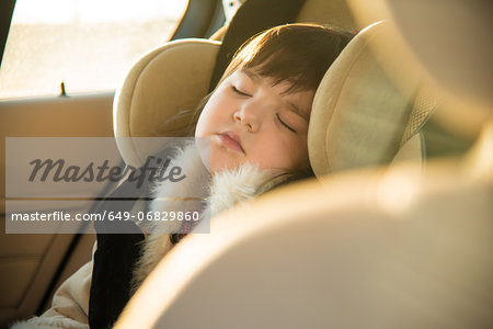 Young girl sleeping in car