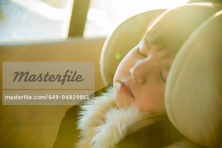 Close up of young girl sleeping in car