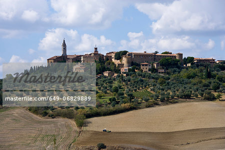 Ploughed fields and Tuscan town of Pienza, Italy