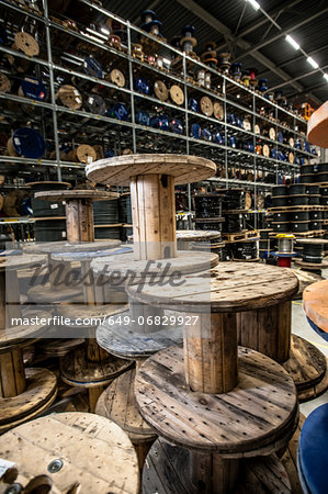 Empty cable drums stacked in warehouse