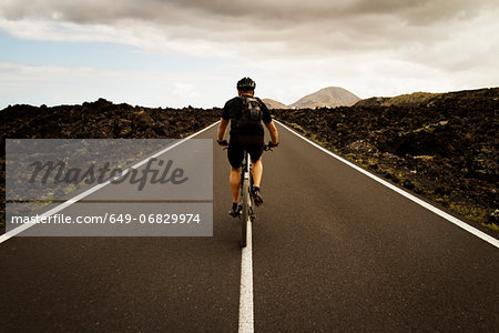 Man mountain biking on road, Lanzarote