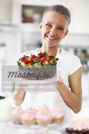 Portrait of woman holding cake with strawberries Portrait of woman holding cake with strawberries
