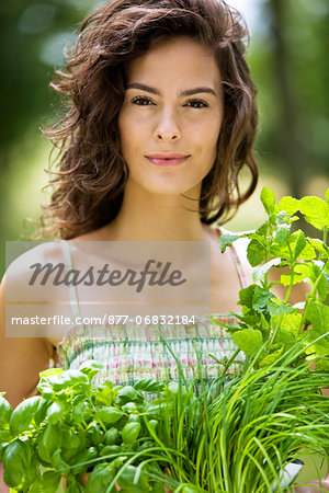 Young woman with aromatic herbs