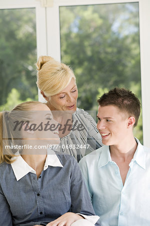 Mature woman discussingt with two teenagers