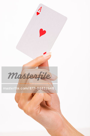 Woman's hand holding a playing card (ace of heart)