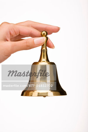Woman's hand holding a little bell