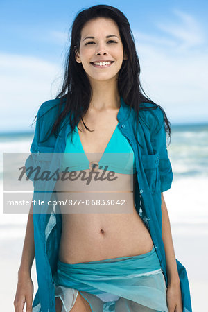 Brown-haired young woman on the beach, summer