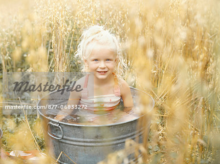 Little girl in metal basin