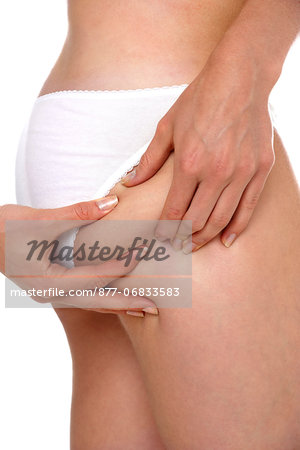 Woman pinching cellulite