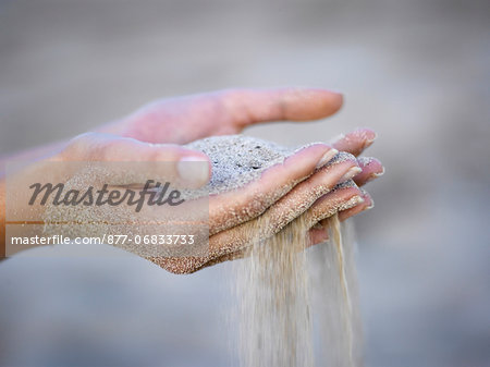 Woman's hands with sand