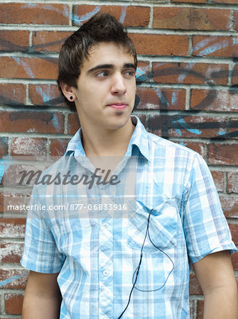 Teenage boy leaning against wall