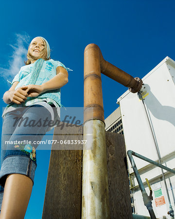 Teenage girl on building roof