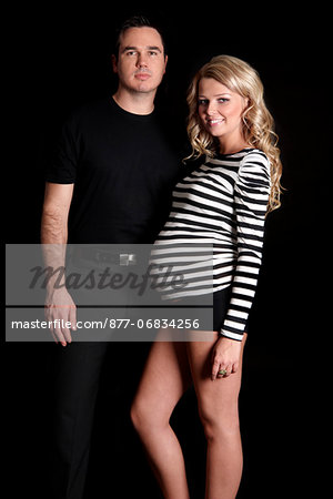 Pregnant woman and man smiling for camera